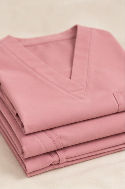 A folded stack of SUB. scrubs